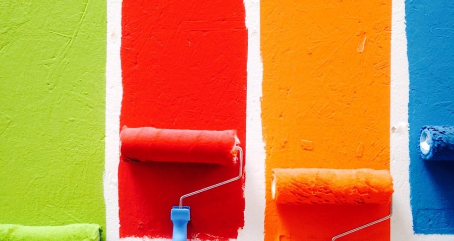 four orange, green, blue, and red paint rollers