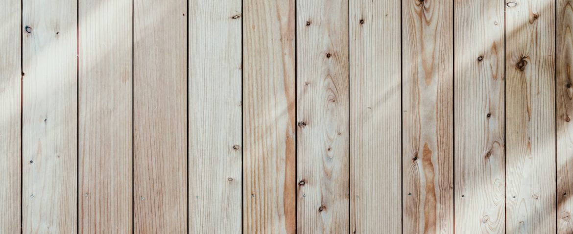 a close up of a wooden wall with a light shining on it