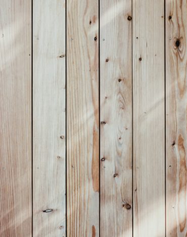a close up of a wooden wall with a light shining on it